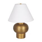 Gold table lamp with a white shade on a white background
