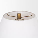 Gold table lamp with a white shade on a white background