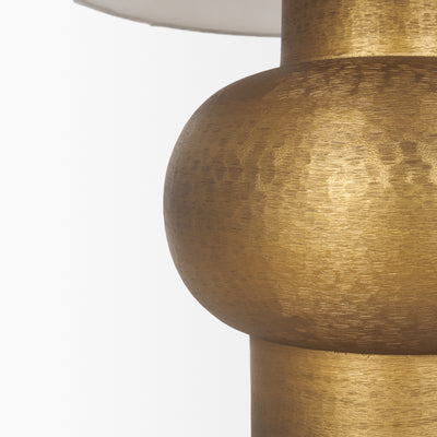 Gold table lamp with a white shade on a white background