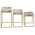 Set of three marble-top side tables with gold frames on a white background