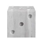 close-up to a gray marble dice decor object with multiple holes on each face, resembling dice numbers.
