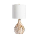 Table lamp with a marbled base and white shade on a white background