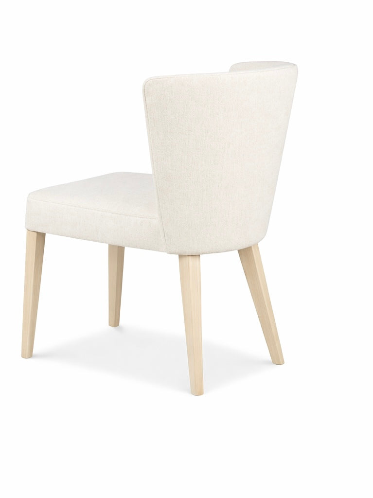 White upholstered chair with light wood legs on a white background