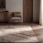 Living room with a textured area rug, wooden chair, and side table.