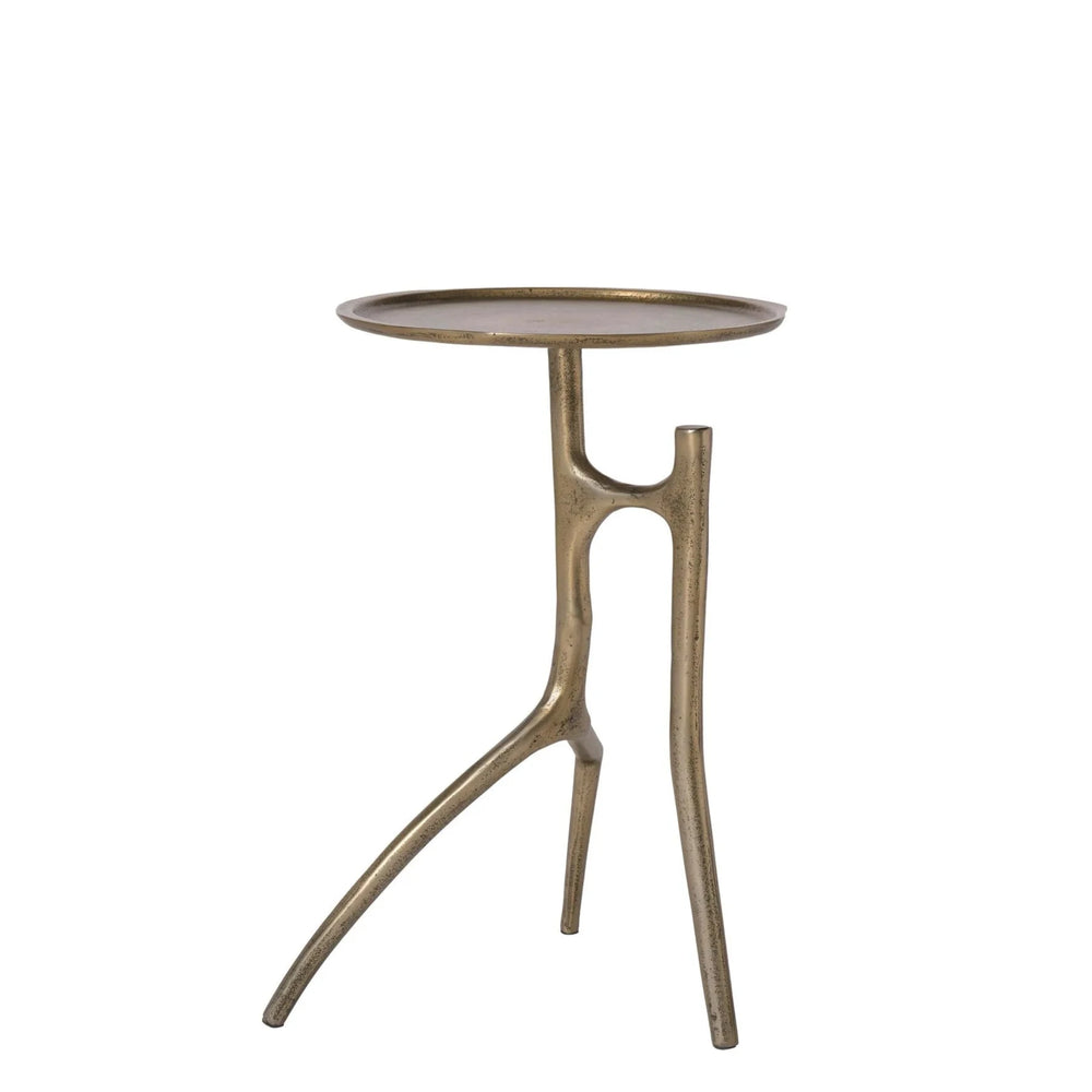 A chair-side table with a brass finish, featuring a single visible leg and a flat, circular top.