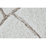 Close-up of textured beige carpet with a subtle pattern