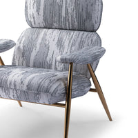 Gray patterned armchair with brass legs on a white background