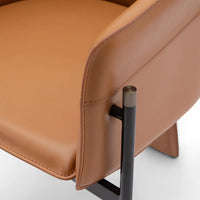 Close-up of a brown leather chair with a metal leg on a white background
