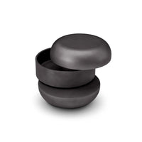 Set of three black ceramic bowls stacked on a white background
