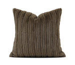 A square throw pillow in a textured, ribbed corduroy-like fabric in a warm taupe-brown color, shown against a plain white background