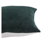 Dark green pillow with a white patch on a white background