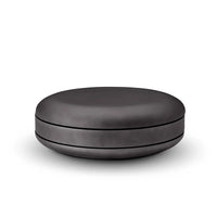 Black round ottoman on a white background