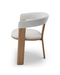 Modern chair with white cushioned seat and backrest on a white background