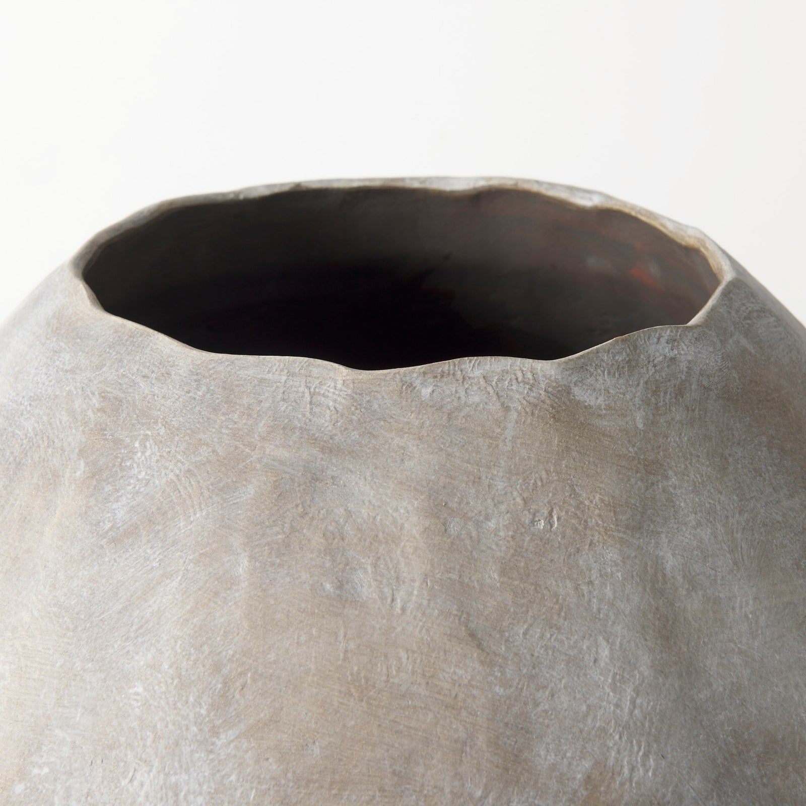 Close-up of a textured ceramic vase on a white background
