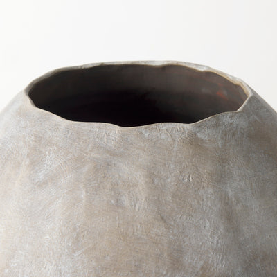 Close-up of a textured ceramic vase on a white background