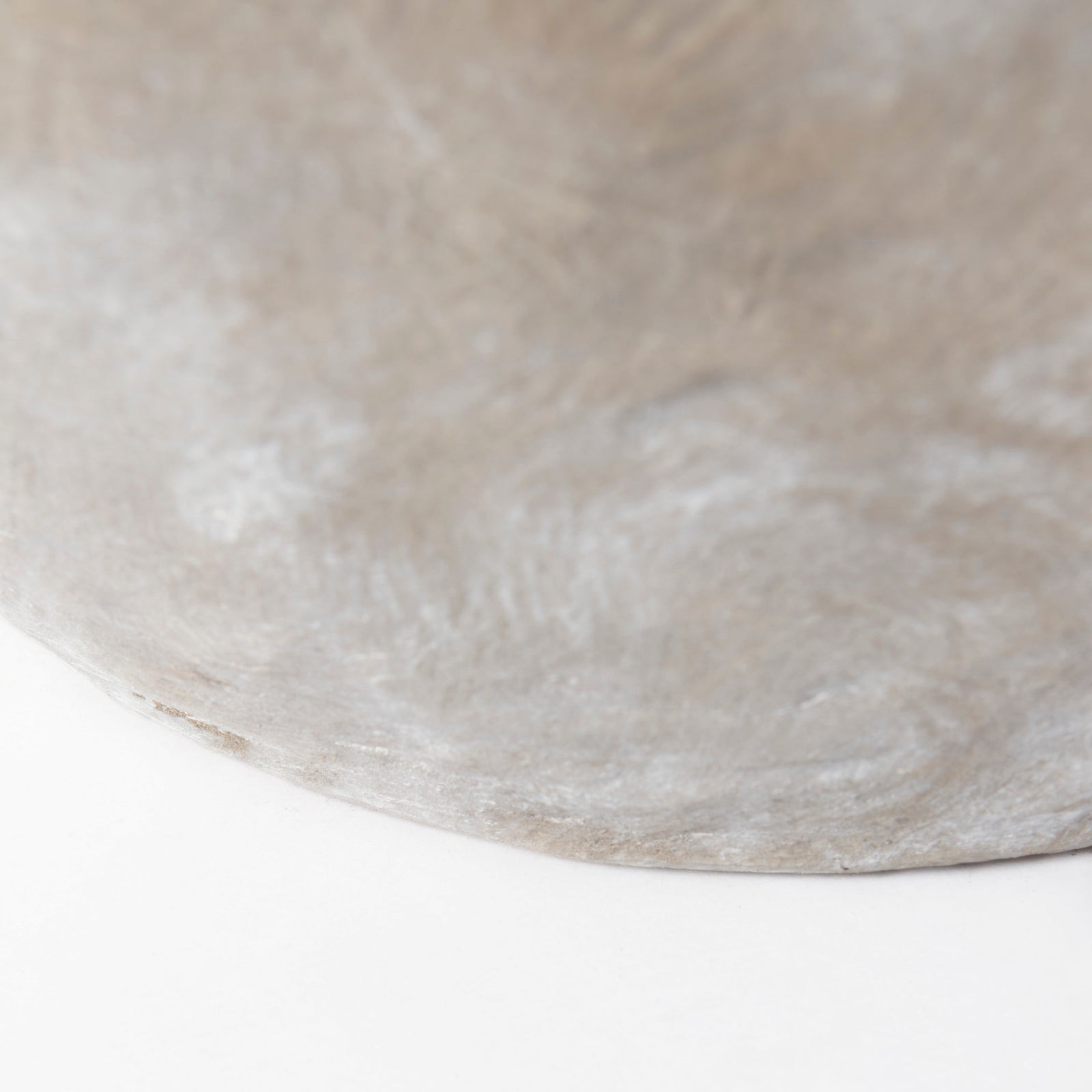 Close-up of a textured concrete surface on a white background