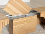 Wooden table with a hinge mechanism on a carpeted floor