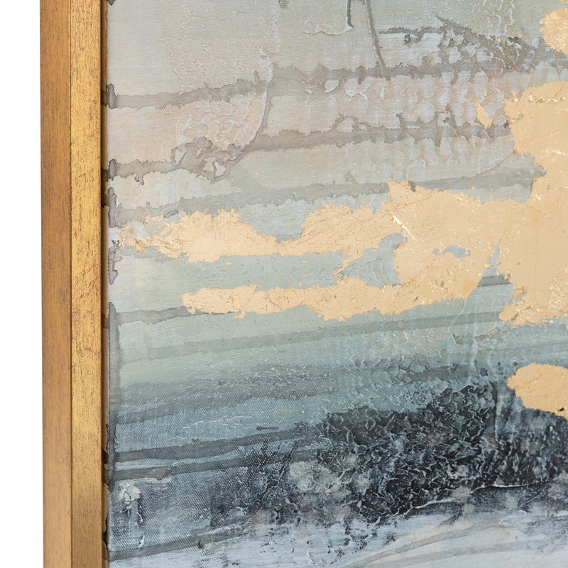 A framed abstract painting featuring shades of blue and white with gold accents, creating a serene ocean-like effect.