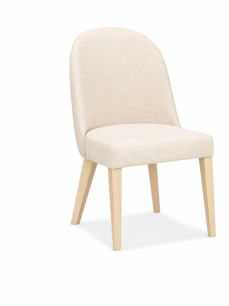 Beige upholstered chair with wooden legs on a white background