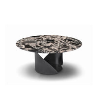 Round marble table with a black and white pattern on a white background