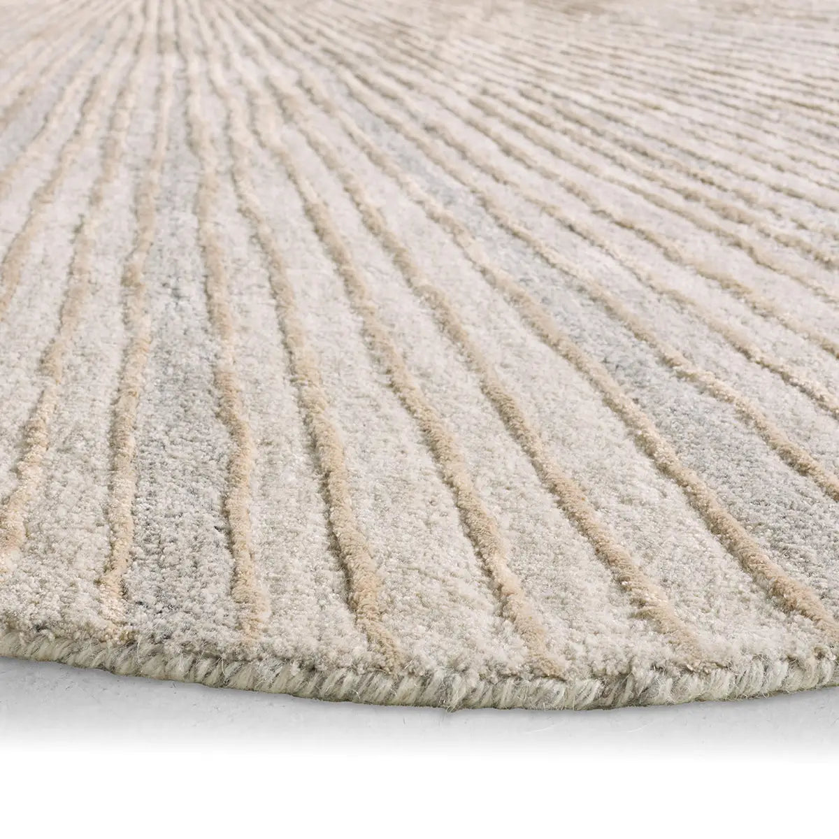 Close-up of a textured beige rug with wavy pattern on a light gray background