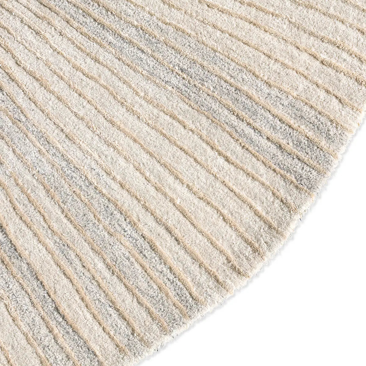 Close-up of a textured rug with horizontal lines in beige and gray.
