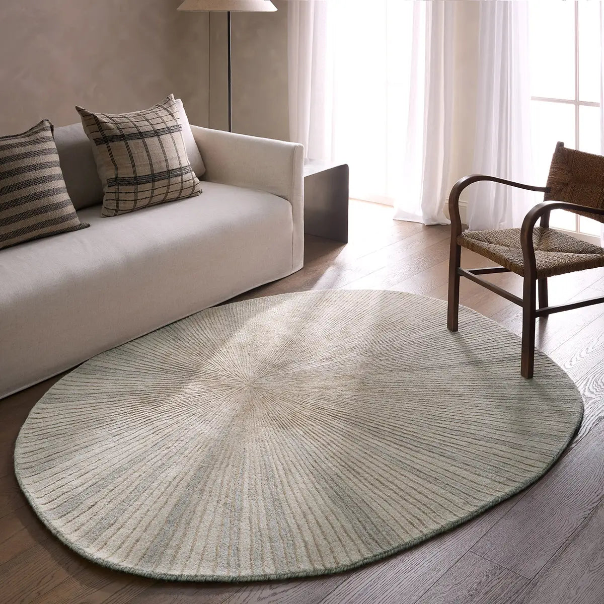 Round green rug in a living room with a sofa and chair.