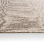 Close-up of a textured beige carpet on a white background