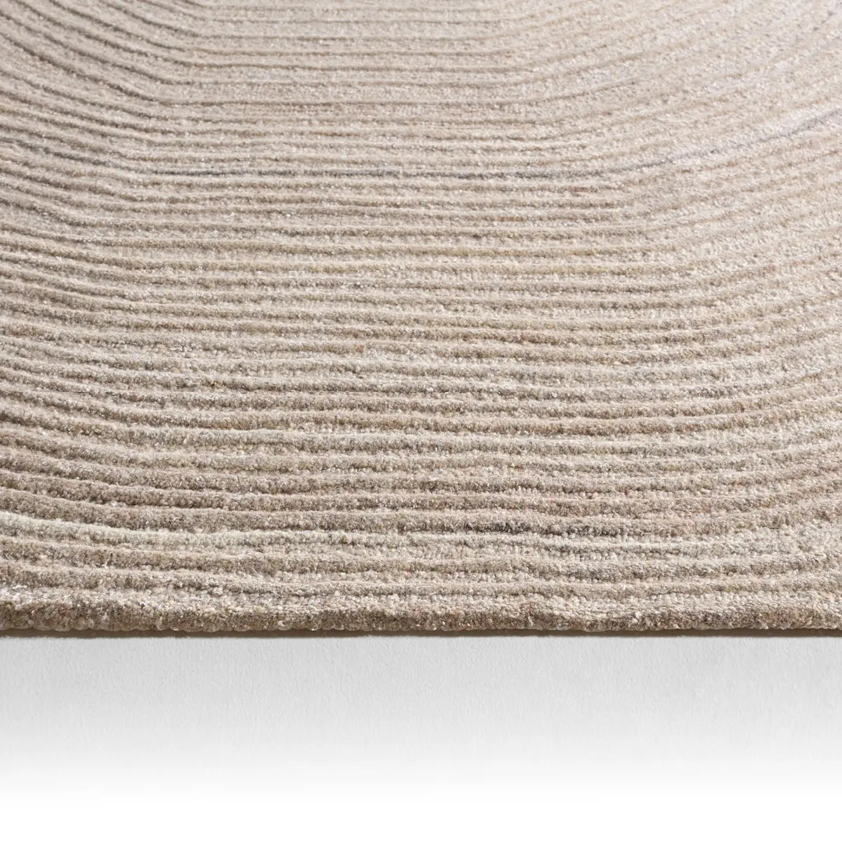 Close-up of a textured beige carpet on a white background