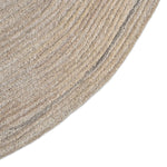 Close-up of a textured beige rug corner on a white background