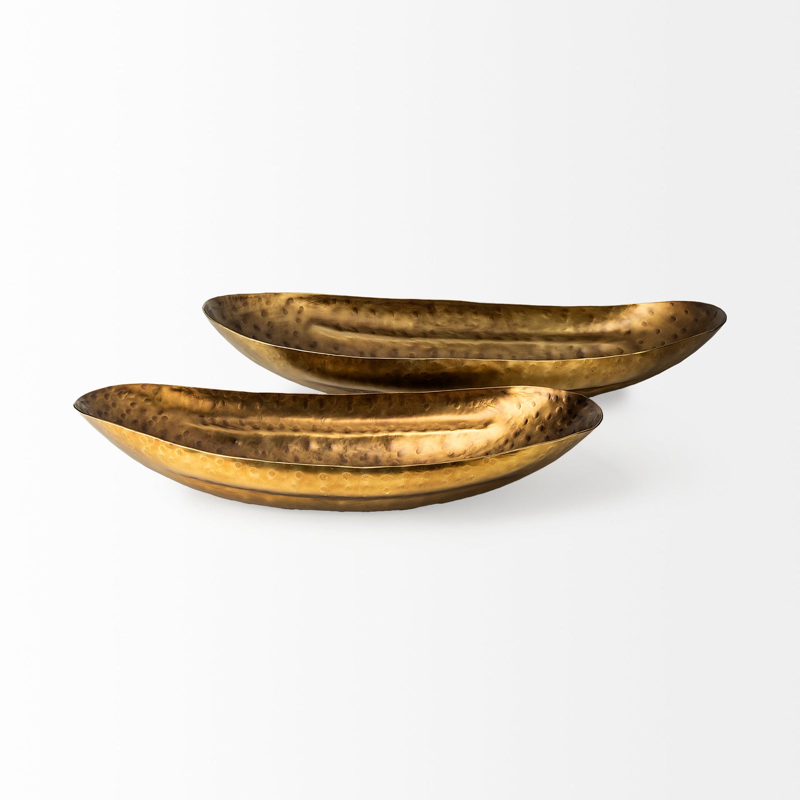 Two antique gold hammered bowls on a white background, designed to resemble oversized boat trays.
