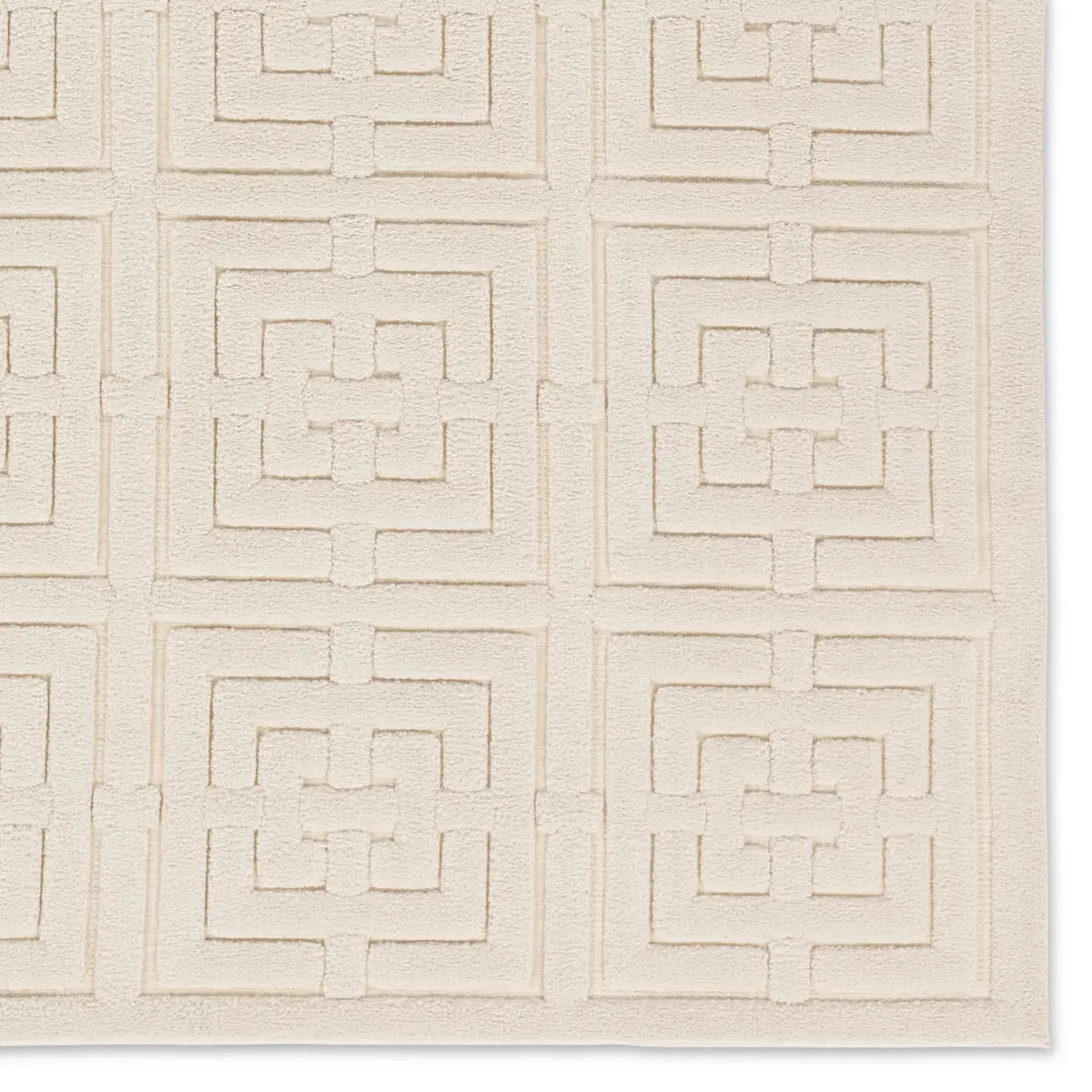 A beige area rug with a geometric pattern