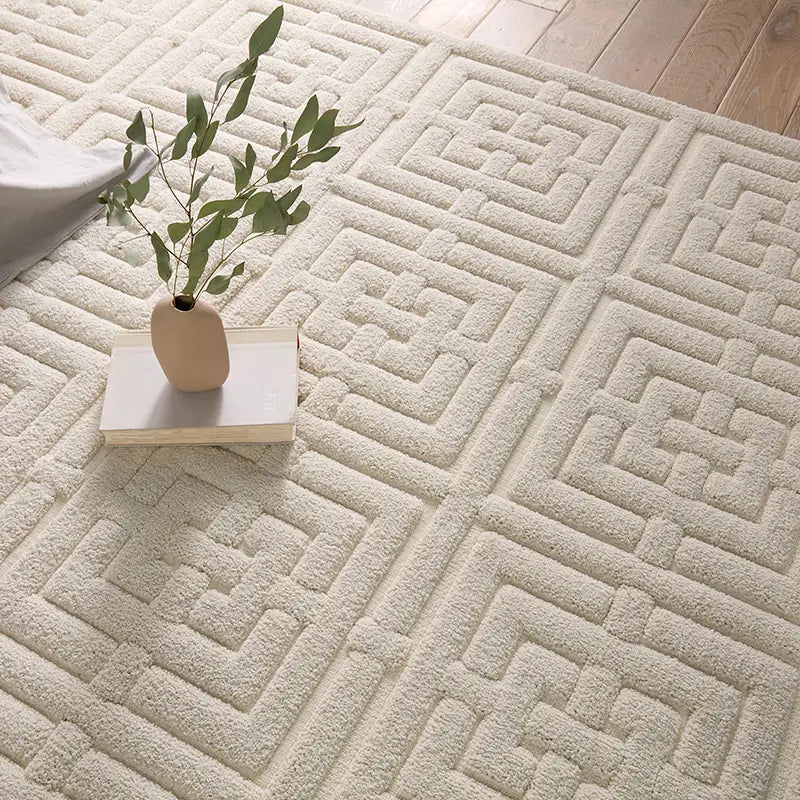 A beige area rug with a geometric pattern
