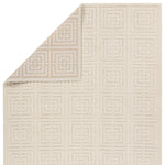 A beige area rug with a geometric pattern