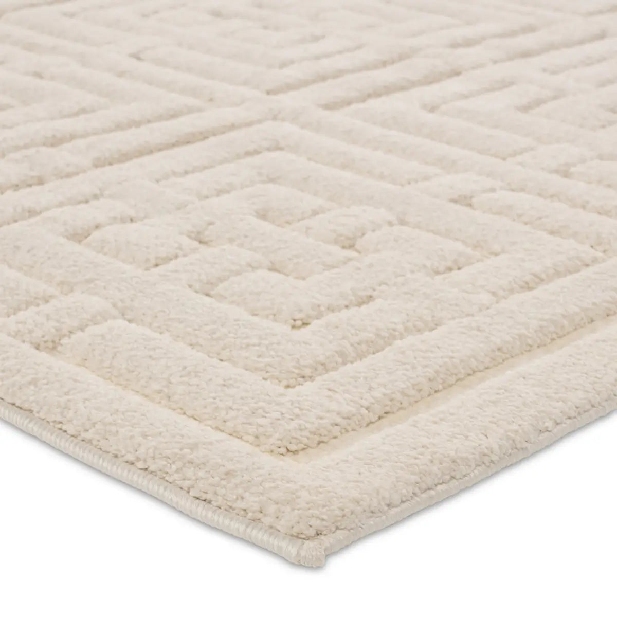 A beige area rug with a geometric pattern