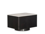 Black cube-shaped table with a white marble top on a white background