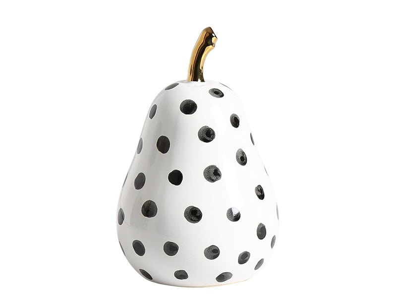 A white porcelain pear-shaped decorative object with black dots
