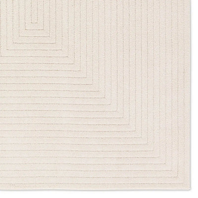 Textured beige area rug with geometric pattern