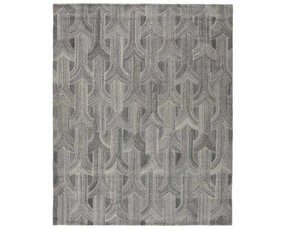 A rectangular wool area rug with a geometric pattern in gray, beige, and other colors.