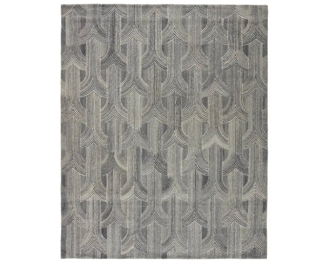 A rectangular wool area rug with a geometric pattern in gray, beige, and other colors.