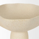 Close up to a beige ceramic bowls with handles on a white background
