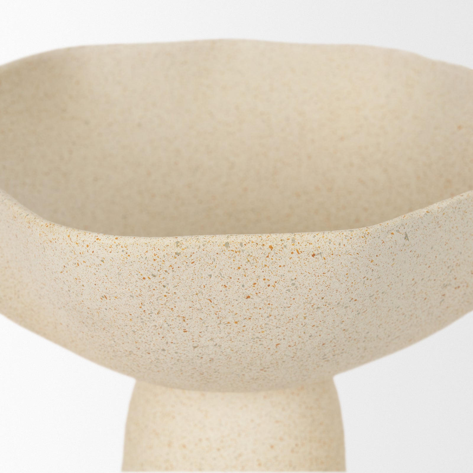 Close up to a beige ceramic bowls with handles on a white background