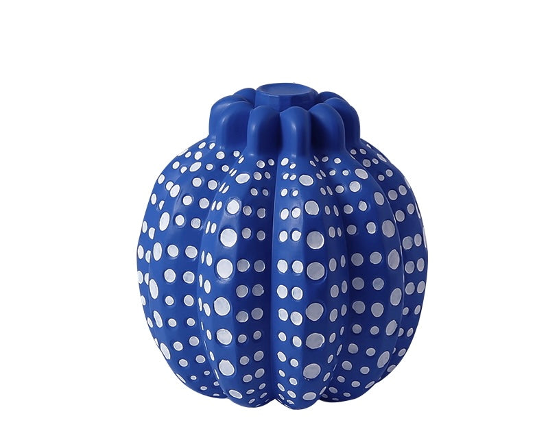A blue pumpkin-shaped decorative object with white dots pattern.