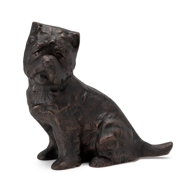 A decorative object in the shape of a sitting puppy with a dark brown finish.