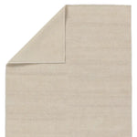 A beige area rug with a flatweave construction, laying on a white background.