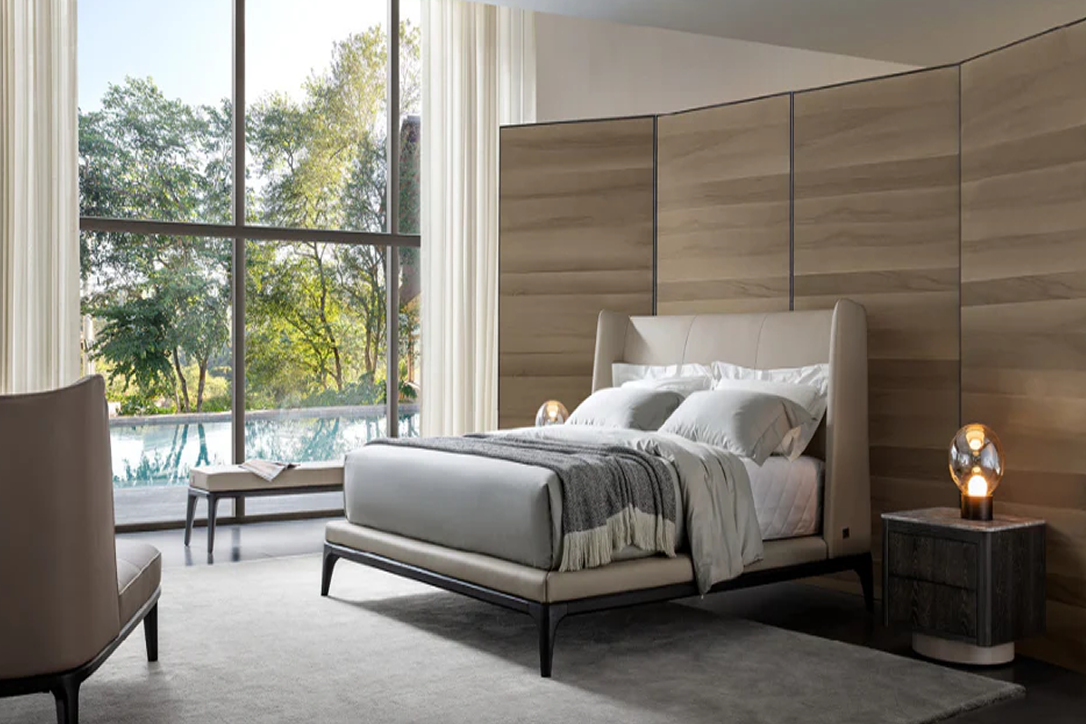 Modern bedroom with a bed, nightstands, and a large window view.