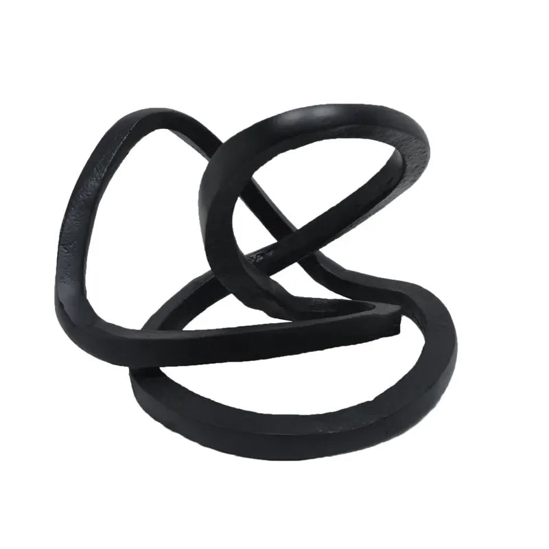 A black ribbon accent decor with an abstract, twisted shape.