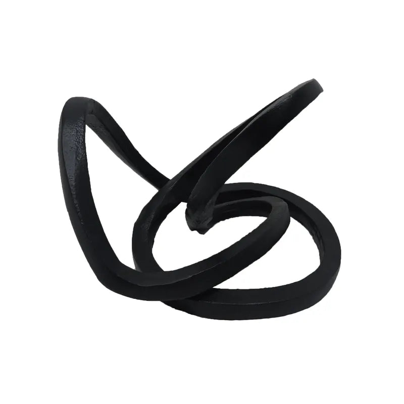 A black ribbon accent decor with an abstract, twisted shape.