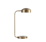 A table lamp with a brass finish, featuring a sleek, modern design with a rounded shade and a flat base.