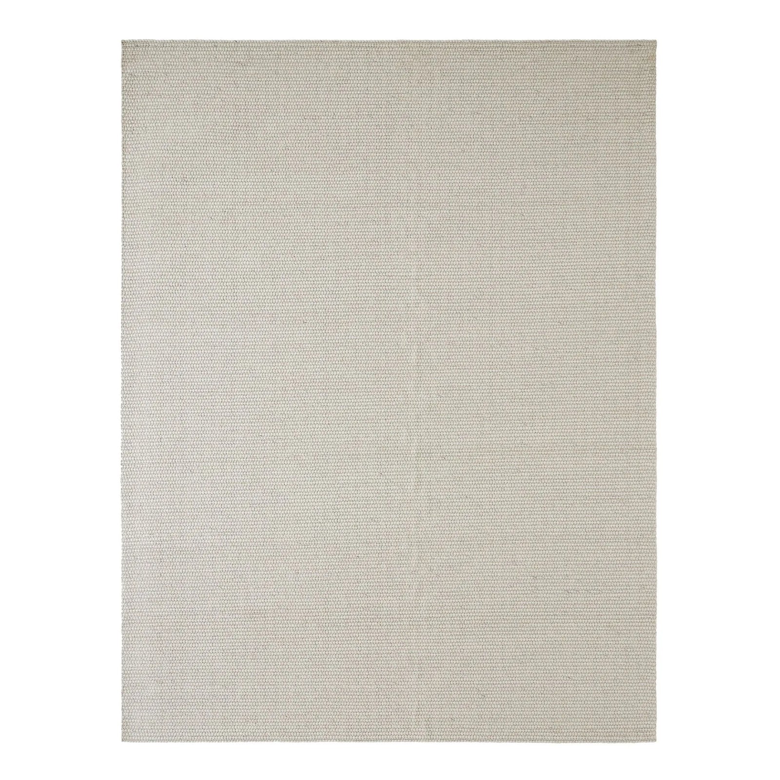 Beige area rug on a white background